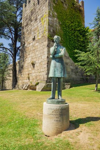 Porto Portugal 13 July 2021 View of the statue of Almeida Garrett stands serenely against the weathered stones of the Torre dos Clérigos a verdant cascade of ivy softening its ancient facade. Porto Portugal 13 July 2021 View of the statue of Almeida Garrett stands serenely against the weathered stones of the Torre dos Clérigos a verdant cascade of ivy softening its ancient facade.