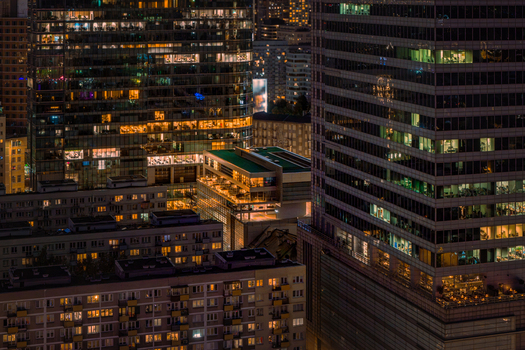 Aerial view of a modern business center with illuminated skyscrapers and office windows at night in Warsaw Masovian Voivodeship Poland.