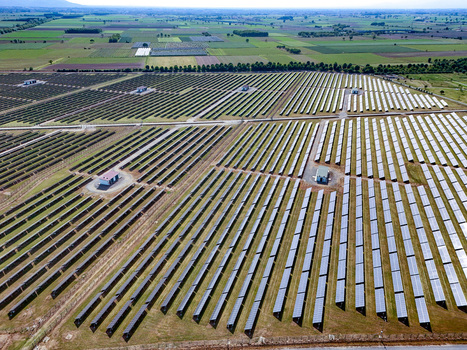 Aerial view of a large solar panel farm with rows of photovoltaic panels and utility buildings in Torrazza Piemonte Piemonte Italy. Aerial view of a large solar panel farm with rows of photovoltaic panels and utility buildings in Torrazza Piemonte Piemonte Italy.