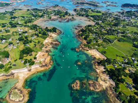 Aerial view of Brehat island featuring turquoise waters rocky inlets sandy beaches and green coastal landscapes Ile de Brehat Brittany France.