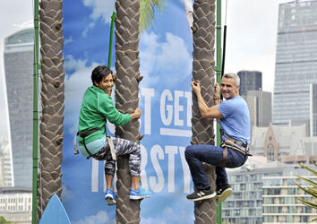 Dame Kelly Holmes climbs up a 23ft coconut tree at the Vita Coco Coconut Grove in Potters Fields London