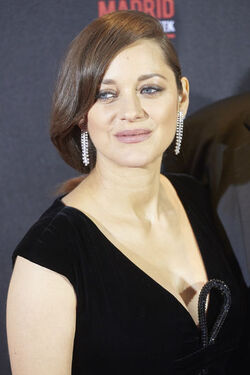 Pregnant Marion Cotillard leans in to speak to Brad Pitt as the pair promote their new film Allied in Madrid Spain