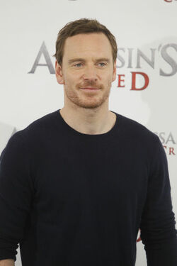 Pregnant Marion Cotillard covers her bump in a loose white Area shirt as she poses with Michael Fassbender at the Assasin s Creed Photocall Madrid