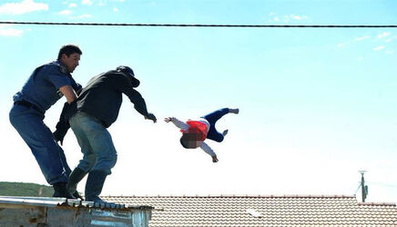 Heart stopping moment South African dad throws his own toddler off roof in protest at illegal shack being demolished Heart stopping moment South African dad throws his own toddler off roof in protest at illegal shack being demolished