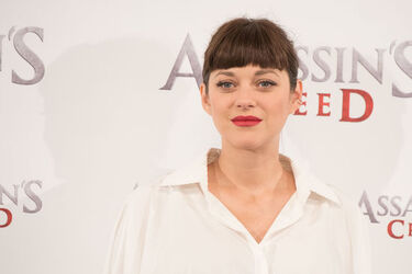 Pregnant Marion Cotillard covers her bump in a loose white Area shirt as she poses with Michael Fassbender at the Assasin s Creed Photocall Madrid