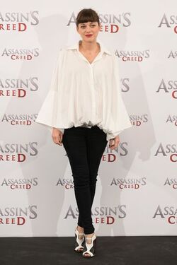 Pregnant Marion Cotillard covers her bump in a loose white Area shirt as she poses with Michael Fassbender at the Assasin s Creed Photocall Madrid