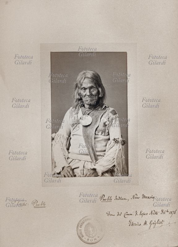 NATIVE AMERICA an elderly Pueblo in traditional dress; New Mexico. Tribe: Pueblo. Collection Henry H. Giglioli. Photography gift of Comm. F. Lopes-Netto, December 1876.