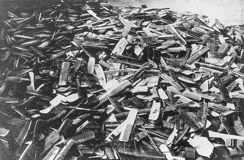 WWII NAZISM Auschwitz, the mountain of combs belonging to the gassed in a corner of the enormous warehouse that collected the personal effects of the exterminated, the \
