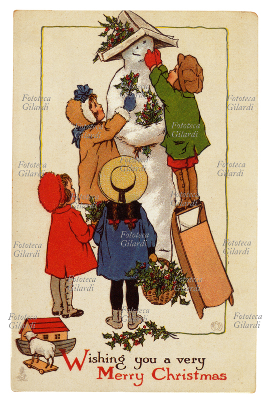 NATALE Il pupazzo di neve. Quattro bambini lo decorano con un berretto di carta e rametti di agrifoglio.Cartolina augurale natalizia dei primi del \