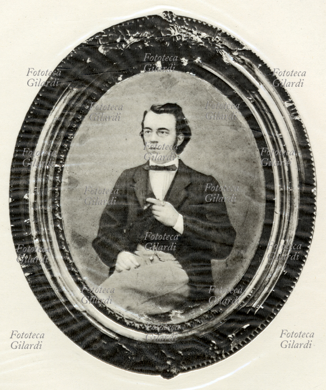 HISTORY OF PHOTOGRAPHY photographic reproduction of a male portrait in daguerrotipo realized by the Swiss engraver and daguerrotipista Johann Baptist Isenring (12 May 1796 - 9 April 1860). The author completed the daguerrotipo with a manual coloring that applied in register of the metal plate, on a very thin glass plate. In this photograph the only daguerrotype slab with its frame is reproduced (see also: FSNgilardi_74016.jpg and FSNgilardi_74017.jpg). Switzerland, St. Gallen, circa 1860.