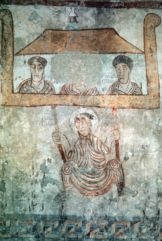 PROCOLO of Verona (? – 304), fourth bishop of the Venetian diocese from 260. Saint Procolo forced to flee from Verona, having descended beyond the walls during the persecution, fresco from the Carolingian period (sometimes identified instead with Saint Paul of Tarsus, 4 – 64 or 67, fleeing from Damascus). The saint will later return to his office. Naturno (Bolzano), 9th century.