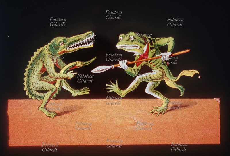 FABLES Animals anthropomorphs: a frog in tail coat, armed with nozzle, it tries to move away a crocodile that appeals the tail like a gun. painting on glass for magic lantern, 19th century