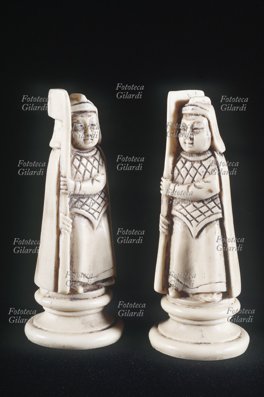 CHESS Pair of white bishops. Pieces made of ivory, the figures are inspired in shape by the medieval era. Italy, 1940s.