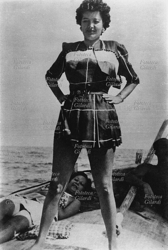 Claretta PETACCI (February 28, 1912 – April 28, 1945) in costume, on a boat, in Riccione. Italy, 1938.