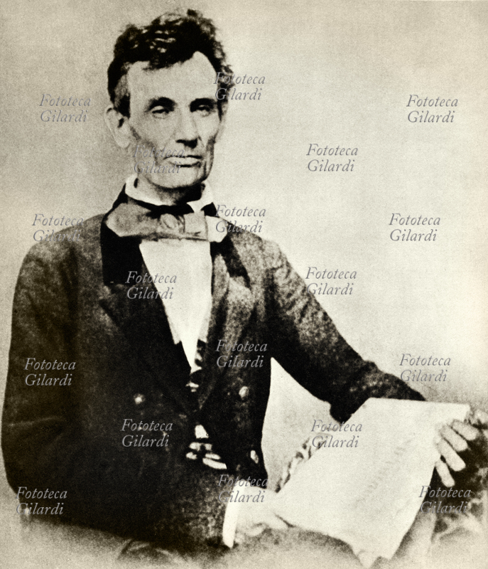 Abraham LINCOLN (12 febbraio 1809 – 15 aprile 1865), politico e avvocato statunitense, 16º presidente degli Stati Uniti dal 4 marzo 1861, il primo appartenente al Partito Repubblicano. Ritratto fotografico a mezzo busto con in mano un giornale. Stati Uniti d\