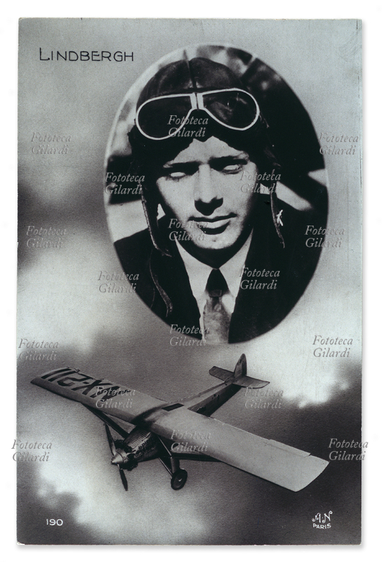 Charles LINDBERGH (19021974) cartolina postale dedicata al celebre aviatore ed al suo velivolo: N-X-211. Il ritratto è racchiuso in un ovale ed è fotomontato su un fondo di cielo e nuvole nel quale vola l\