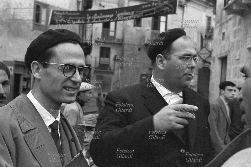 Danilo DOLCI (1924 - 1997) sociologist, educator, poet and activist of Italian nonviolence, in dark jacket, together with prof. Silvio Pampiglione (1929-2008), a doctor from Bologna, specialized in parasitology, communist; photograph by Ando Gilardi, Palma di Montechiaro, 1957