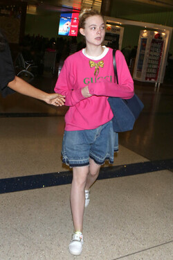 Elle Fanning so pretty in pink Gucci shirt at LAX