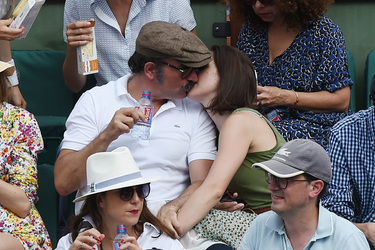 Jean Dujardin and his wife Nathalie Pechalat keep each other moisturised at the French Tennis Open at Roland Garros