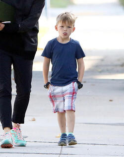 Jennifer Garner carries a school project as she takes her kids to school