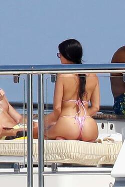 He certainly has some thong to smile about Side boob flashing Kourtney Kardashian s toyboy lover grins as she flaunts her behind in TINY bikini for another day frolicking on a yacht in Cannes