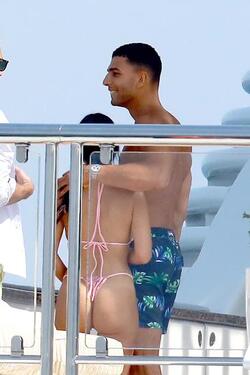 He certainly has some thong to smile about Side boob flashing Kourtney Kardashian s toyboy lover grins as she flaunts her behind in TINY bikini for another day frolicking on a yacht in Cannes