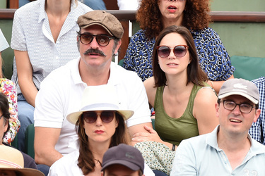 Jean Dujardin and his wife Nathalie Pechalat keep each other moisturised at the French Tennis Open at Roland Garros