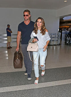 Justin Hartley And Fiance Chrishell Stause Head Out Of LAX On Romantic Holiday