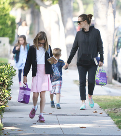 Jennifer Garner carries a school project as she takes her kids to school