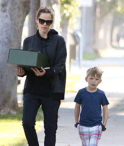 Jennifer Garner carries a school project as she takes her kids to school