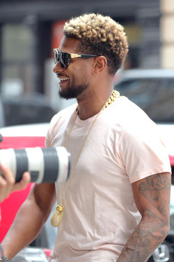 Usher wears comical slippers as he walks in Tribeca