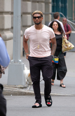 Usher wears comical slippers as he walks in Tribeca