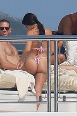 He certainly has some thong to smile about Side boob flashing Kourtney Kardashian s toyboy lover grins as she flaunts her behind in TINY bikini for another day frolicking on a yacht in Cannes