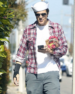 Johnny Knoxville Accesorizes with Sailor Hat and Wrist Brace
