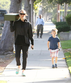 Jennifer Garner carries a school project as she takes her kids to school