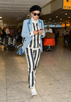 Rita Ora in a Striped Track Suit at Heathrow Airport