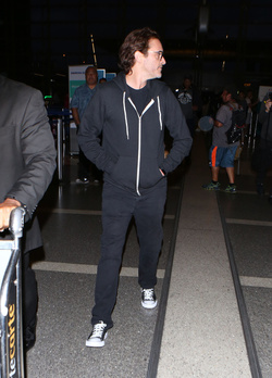 The enigmatic Joaquin Phoenix sports a scruffy beard zip up hoodie and shades as he spends National Brother s Day catching a flight with his lovely sister Summer.