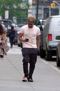 Usher wears comical slippers as he walks in Tribeca