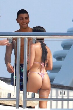 He certainly has some thong to smile about Side boob flashing Kourtney Kardashian s toyboy lover grins as she flaunts her behind in TINY bikini for another day frolicking on a yacht in Cannes