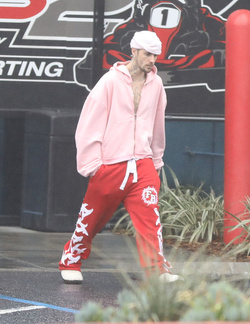 Disheveled Justin Bieber goes go karting in the rain