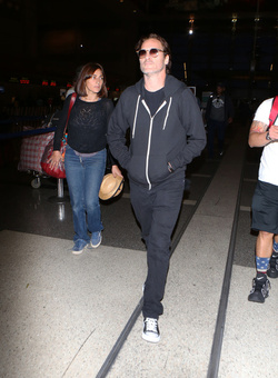 The enigmatic Joaquin Phoenix sports a scruffy beard zip up hoodie and shades as he spends National Brother s Day catching a flight with his lovely sister Summer.