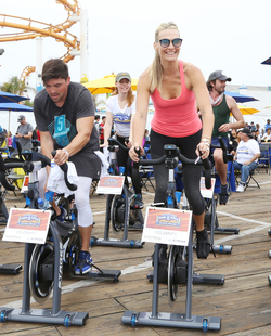 Molly Sims rides a stationary bike for charity