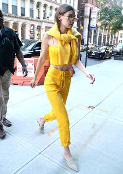 Gigi Hadid wears an all yellow ensemble as she arrives at her apartment