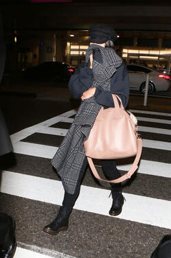 Vanessa Hudgens isn t feeling camera ready and hides her face with a scarf after landing at LAX. Vanessa Hudgens isn t feeling camera ready and hides her face with a scarf after landing at LAX.