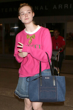Elle Fanning so pretty in pink Gucci shirt at LAX
