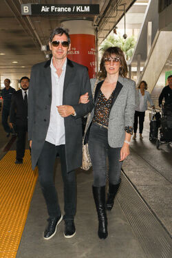 Milla Jovovich and husband director Paul W. S. Anderson were spotted returning to Los Angeles at LAX.