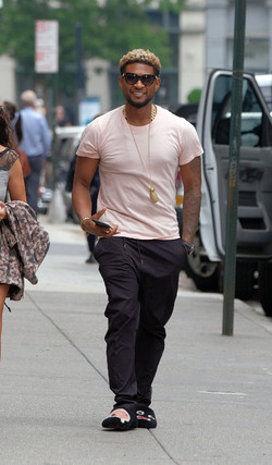 Usher wears comical slippers as he walks in Tribeca