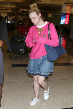 Elle Fanning so pretty in pink Gucci shirt at LAX