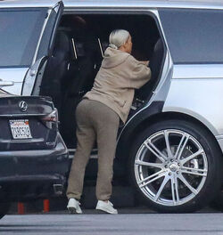 Kim Kardashian carrying a sleepy princess Nori