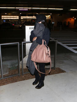 Vanessa Hudgens isn t feeling camera ready and hides her face with a scarf after landing at LAX. Vanessa Hudgens isn t feeling camera ready and hides her face with a scarf after landing at LAX.
